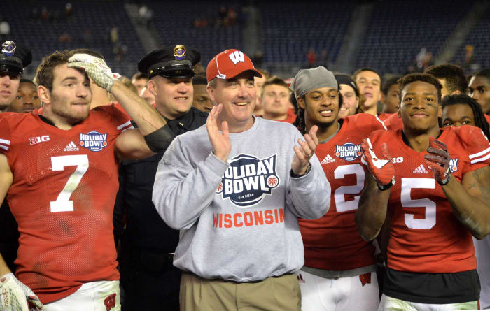Paul Chryst smiling with players after winning the Holiday Bowl.